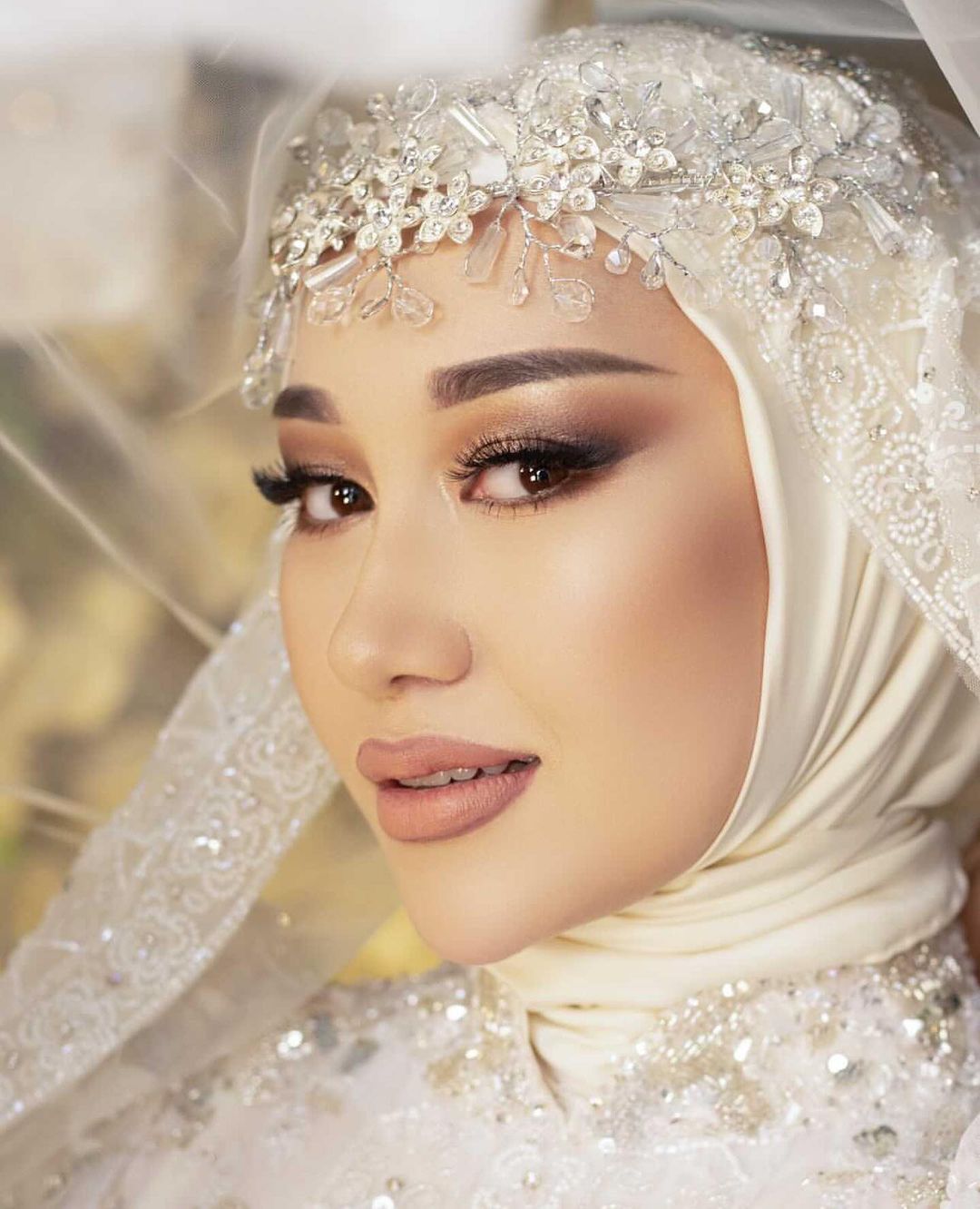 Soft glam bridal makeup on a bride wearing an ivory hijab