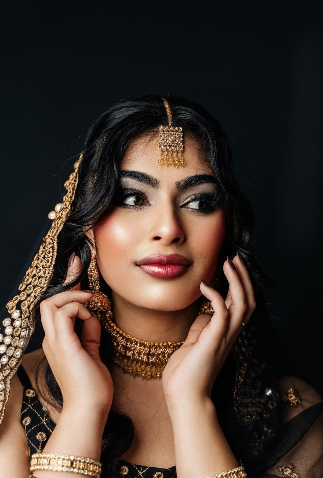South Asian bridal makeup with smoky eyes and black and gold styling